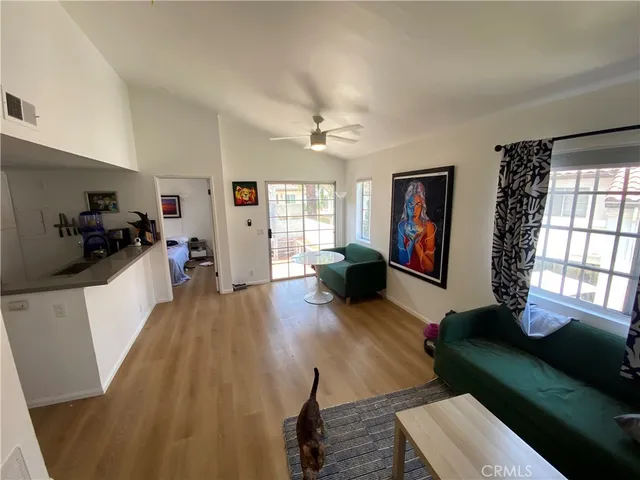a living room with furniture and a wooden floor