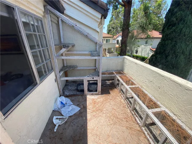 a view of deck with chairs and wooden fence
