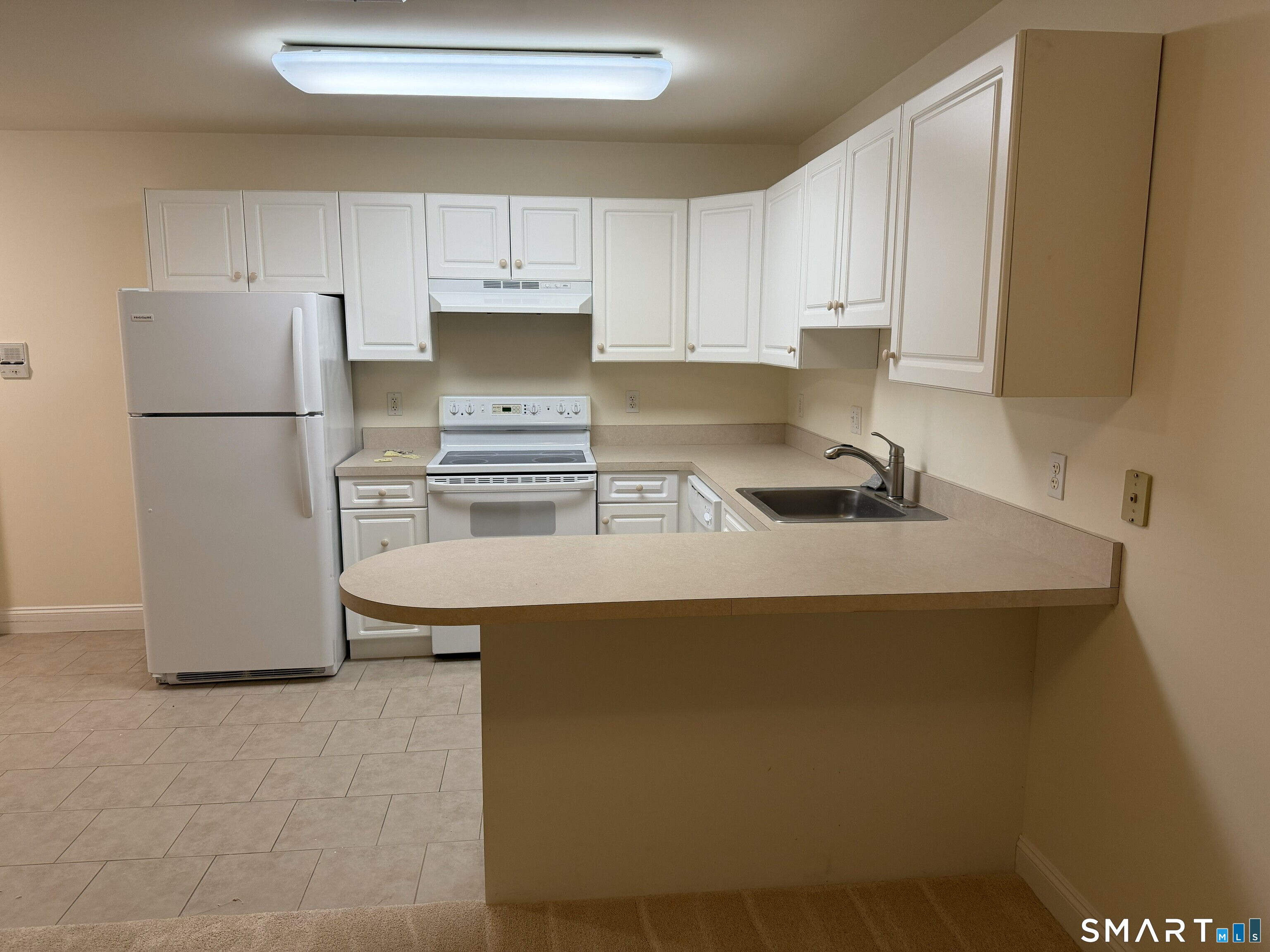 365 Westport Avenue, Unit 2B Norwalk, CT 06851 - Photo 10 of 19 a kitchen with a sink a stove a refrigerator and cabinets