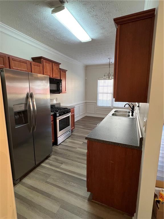 3815 Roses Trail Fairburn, GA 30213 - Photo 3 of 15 a kitchen with kitchen island a counter top space wooden floor and a refrigerator