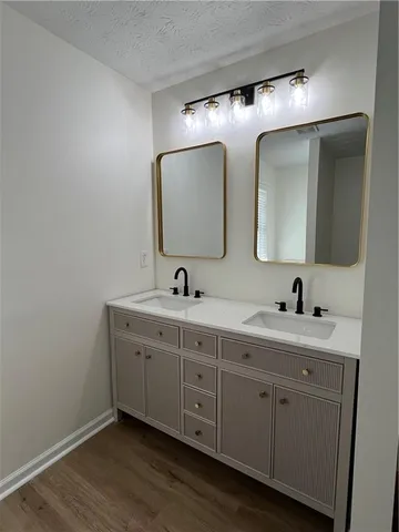 a spacious bathroom with a double vanity sink and mirror