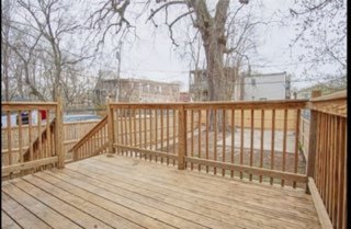 6016 South Carpenter Street Chicago, IL 60621 - Photo 6 of 15 a view of wooden balcony with wooden floor and fence