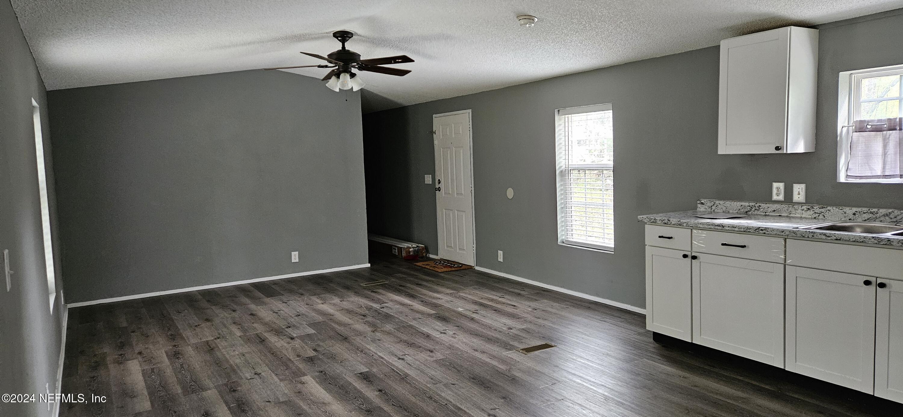 1570 Bluejay Drive Middleburg, FL 32068 - Photo 3 of 17 a view of a kitchen with a sink dishwasher a refrigerator and cabinets