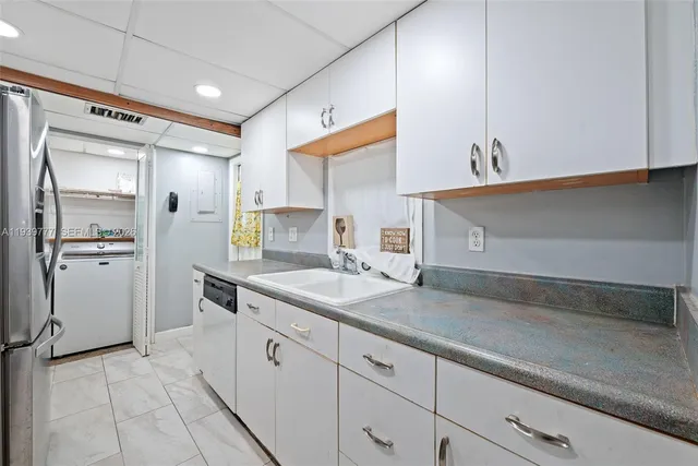 a kitchen with a sink and cabinets