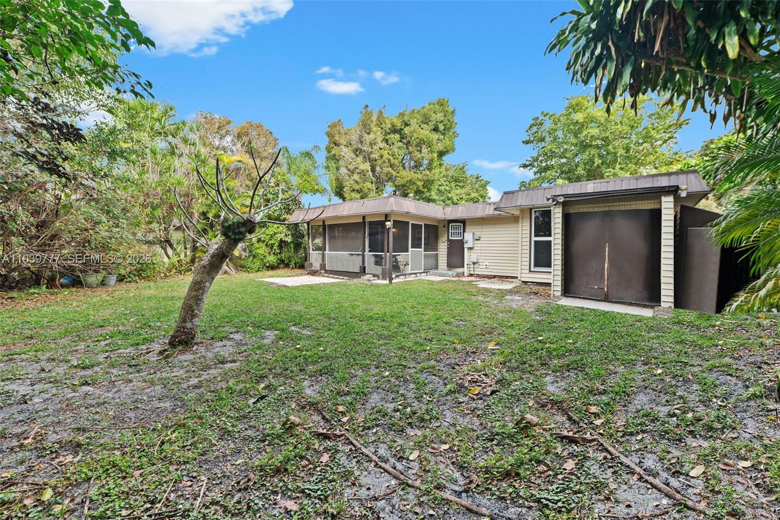 8001 Northwest 68th Terrace Tamarac, FL 33321 - Photo 23 of 27 a front view of a house with garden