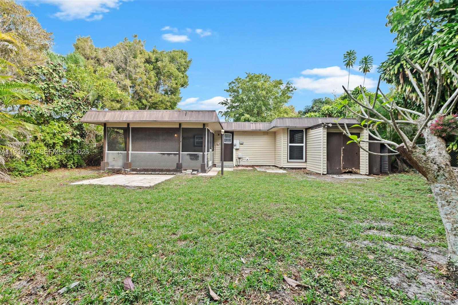 8001 Northwest 68th Terrace Tamarac, FL 33321 - Photo 24 of 27 a front view of a house with a yard