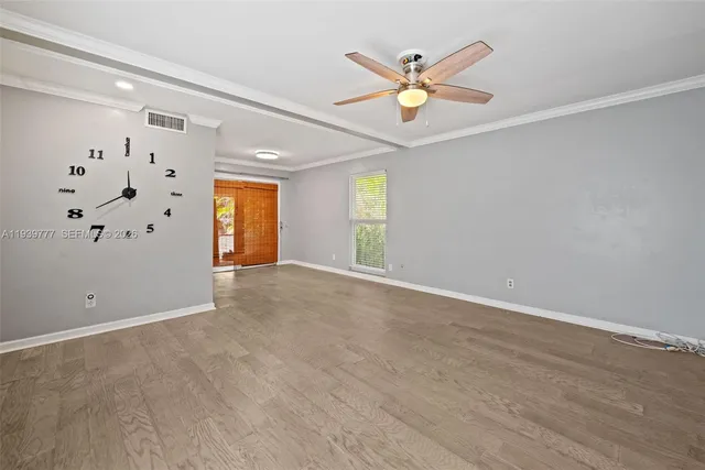 a view of a livingroom with a ceiling fan and window
