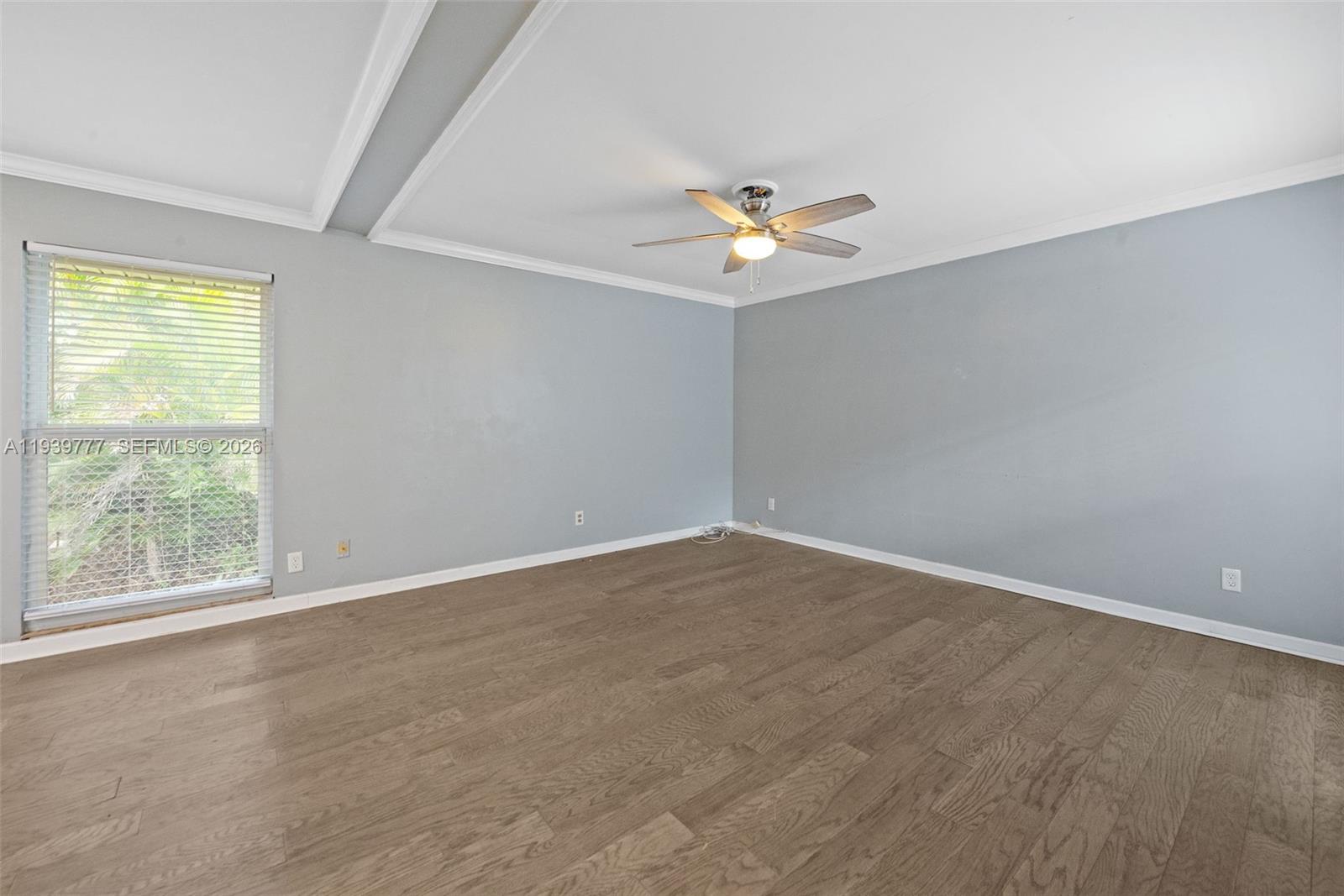 8001 Northwest 68th Terrace Tamarac, FL 33321 - Photo 7 of 27 an empty room with a window and a ceiling fan