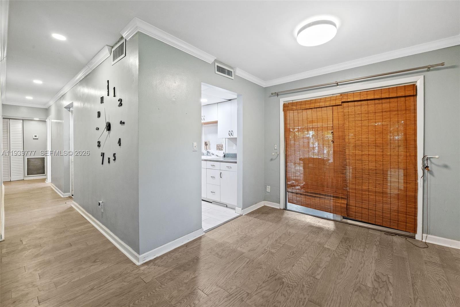 8001 Northwest 68th Terrace Tamarac, FL 33321 - Photo 8 of 27 an empty room with large window and wooden floor