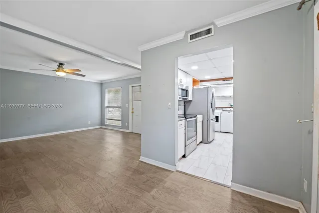 an empty room with cabinet and mirrors