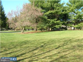 6 Rabbit Run Road Malvern, PA 19355 - Photo 4 of 12 a view of a green field with trees in the background