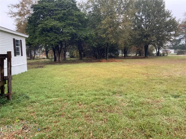 a house view with swimming pool in front of it