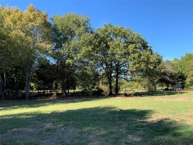 a view of yard with swimming pool and trees