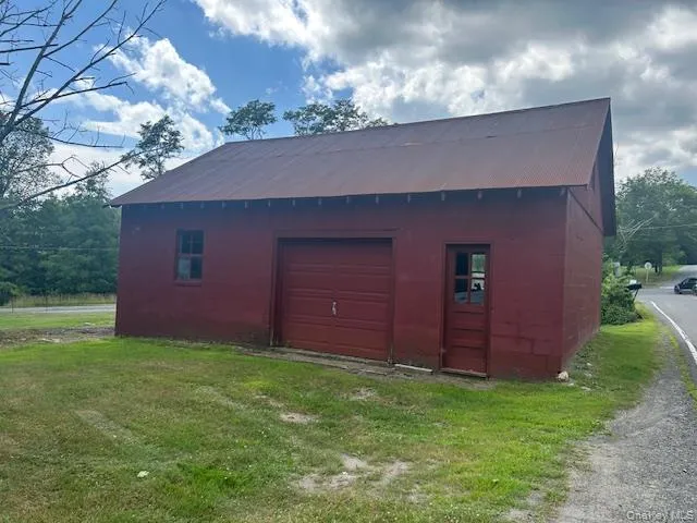 a view of a field with a tree in the background