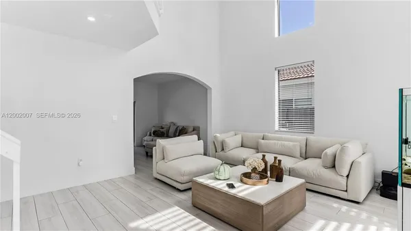 a living room with furniture and wooden floor