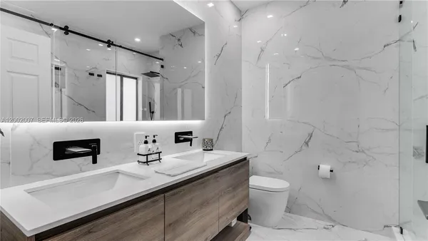 a bathroom with a glass shower door