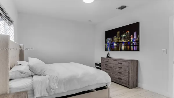 a bedroom with a bed and a dresser