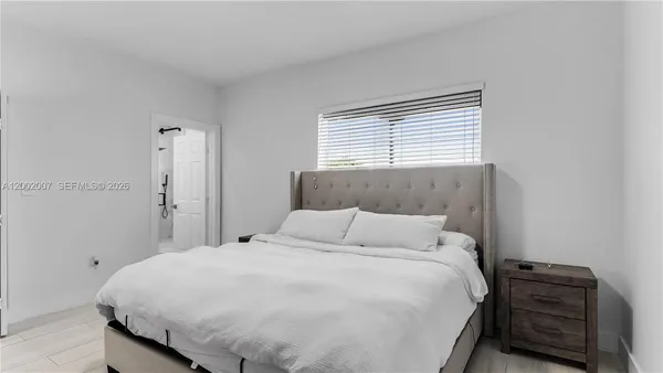 a bed room with a bed and a television