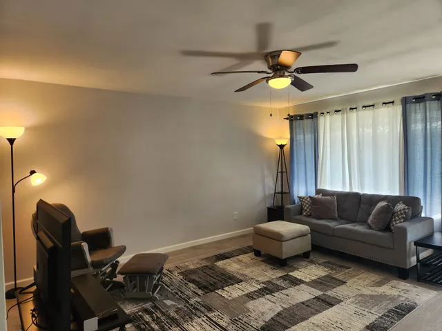 a living room with furniture and a chandelier
