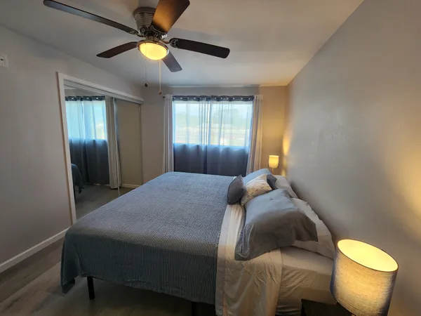 a bedroom with a bed and a chandelier