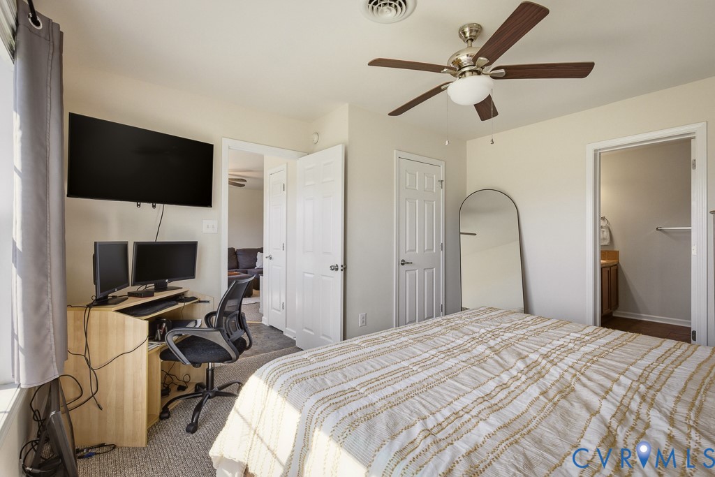 18262 Seals Road Bowling Green, VA 22427 - Photo 26 of 50 a bedroom with a large bed and a flat screen tv
