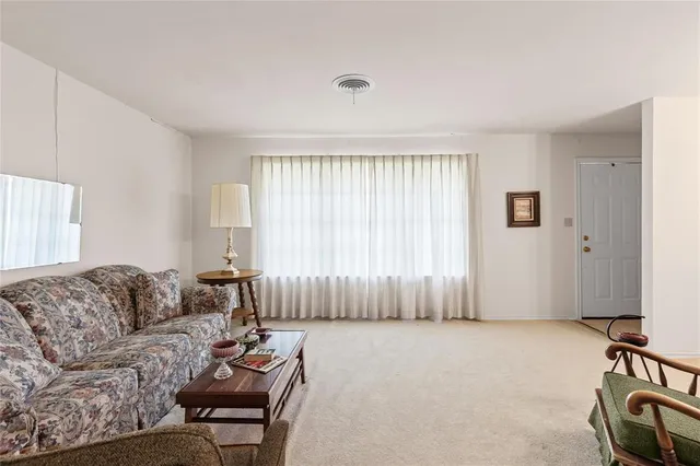 a living room with furniture and a lamp