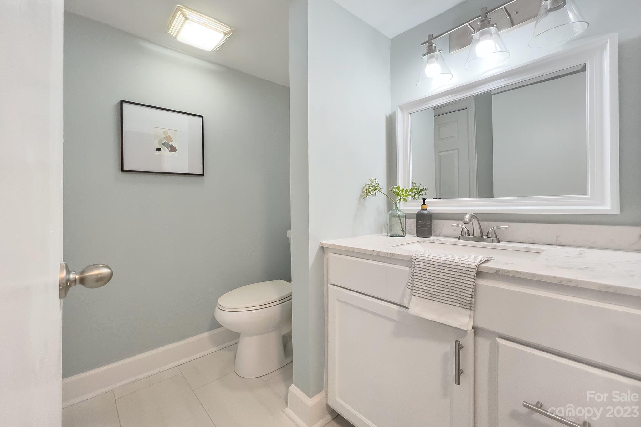 4719 Rounding Run Road Charlotte, NC 28277 - Photo 12 of 48 a bathroom with a toilet sink and mirror