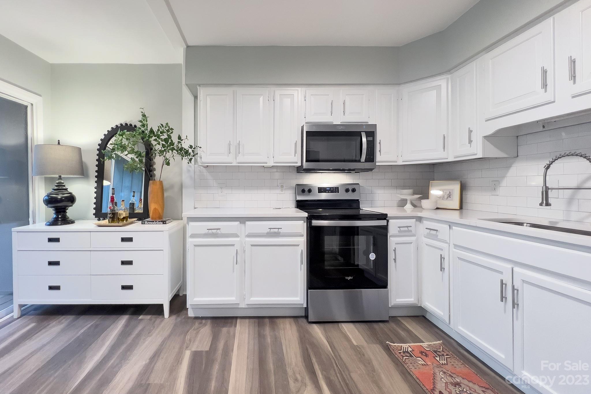 4719 Rounding Run Road Charlotte, NC 28277 - Photo 15 of 48 a kitchen with white cabinets stainless steel appliances and sink