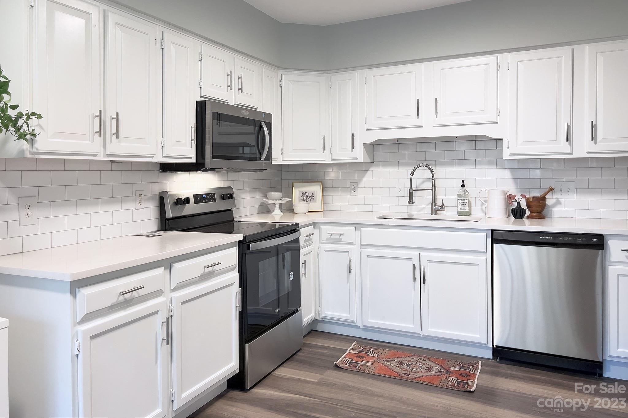 4719 Rounding Run Road Charlotte, NC 28277 - Photo 16 of 48 a kitchen with granite countertop white cabinets and white appliances