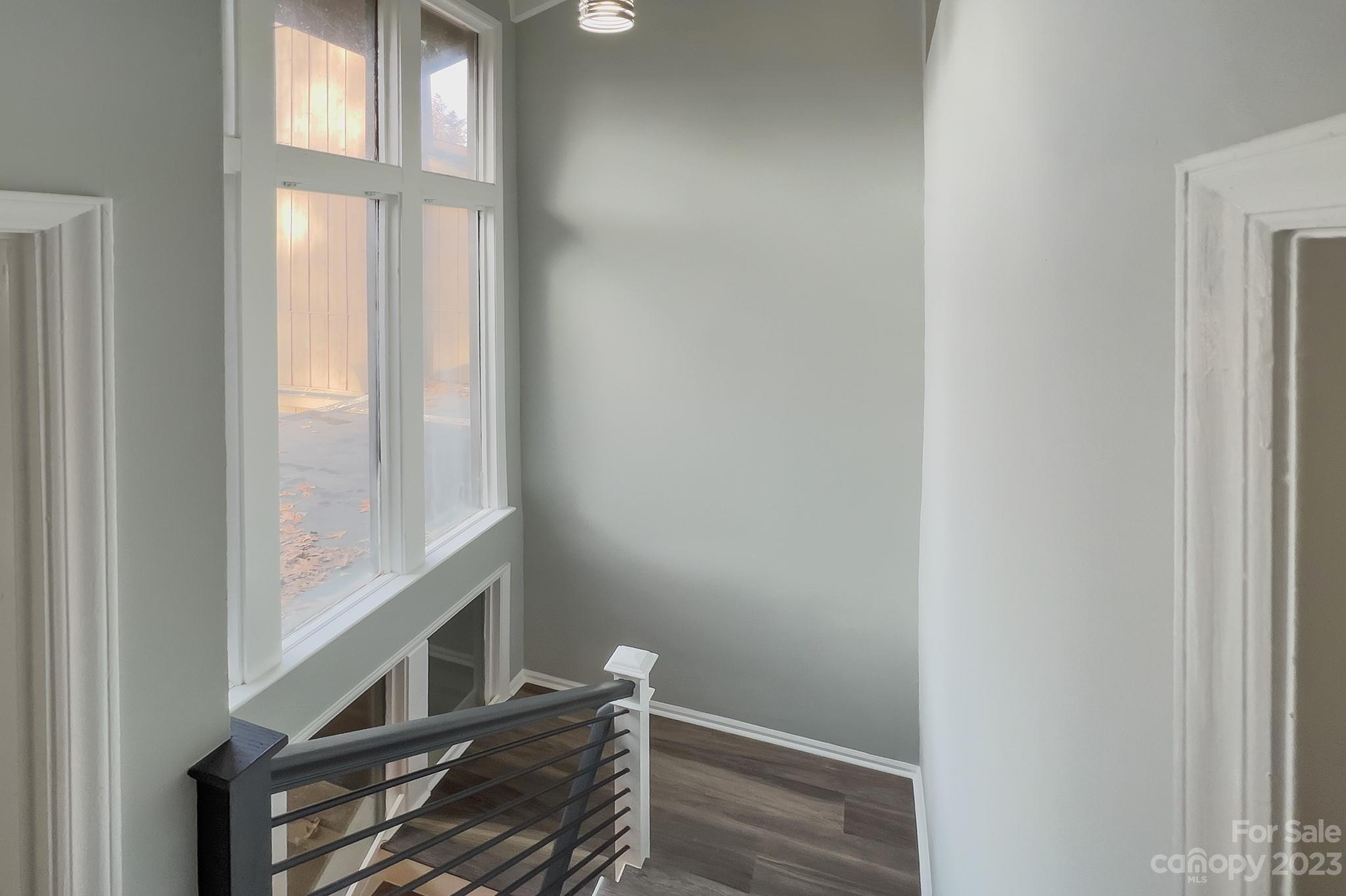 4719 Rounding Run Road Charlotte, NC 28277 - Photo 20 of 48 a view of an empty room with wooden floor and a window