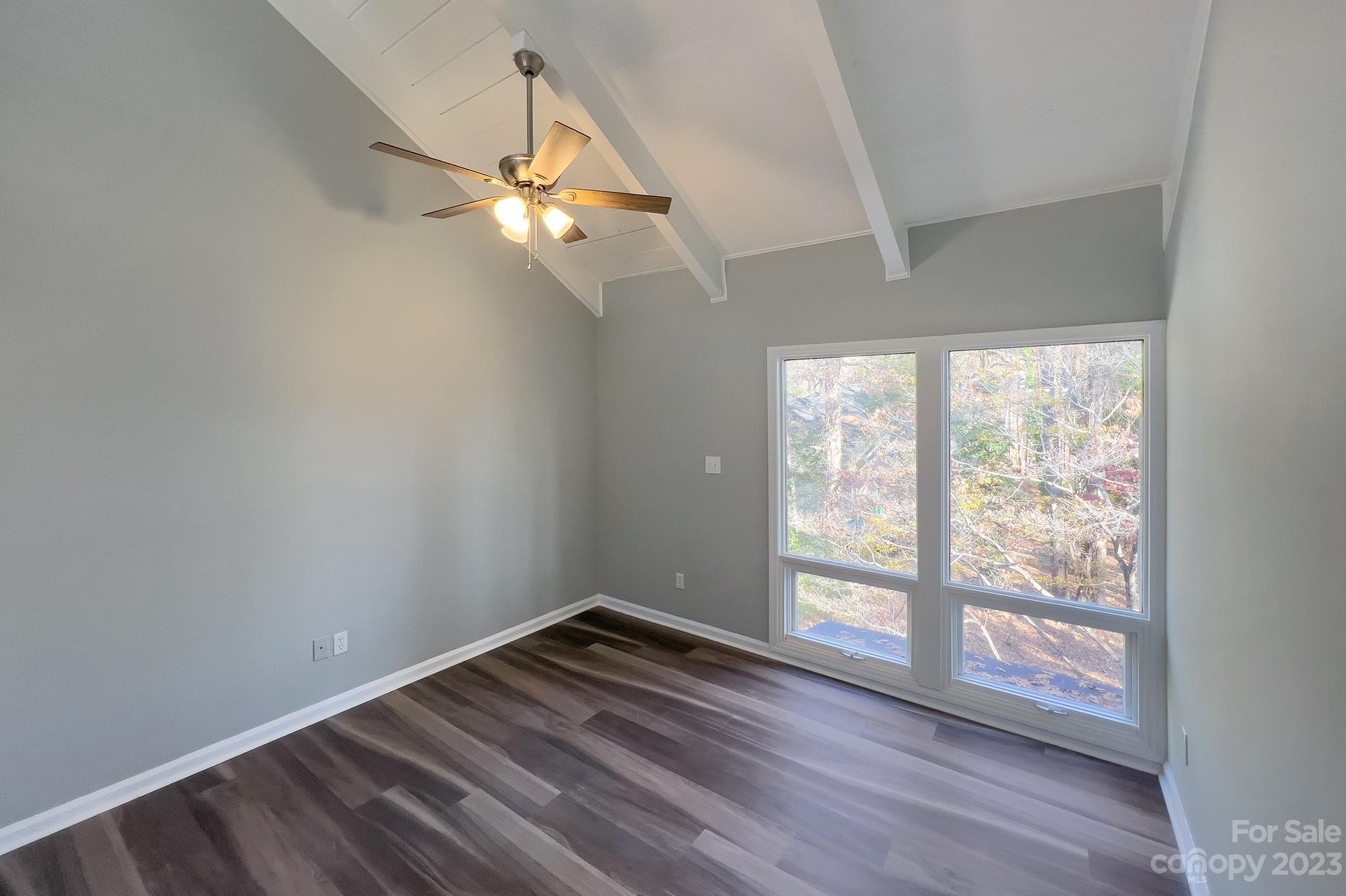 4719 Rounding Run Road Charlotte, NC 28277 - Photo 28 of 48 an empty room with wooden floor fan and windows