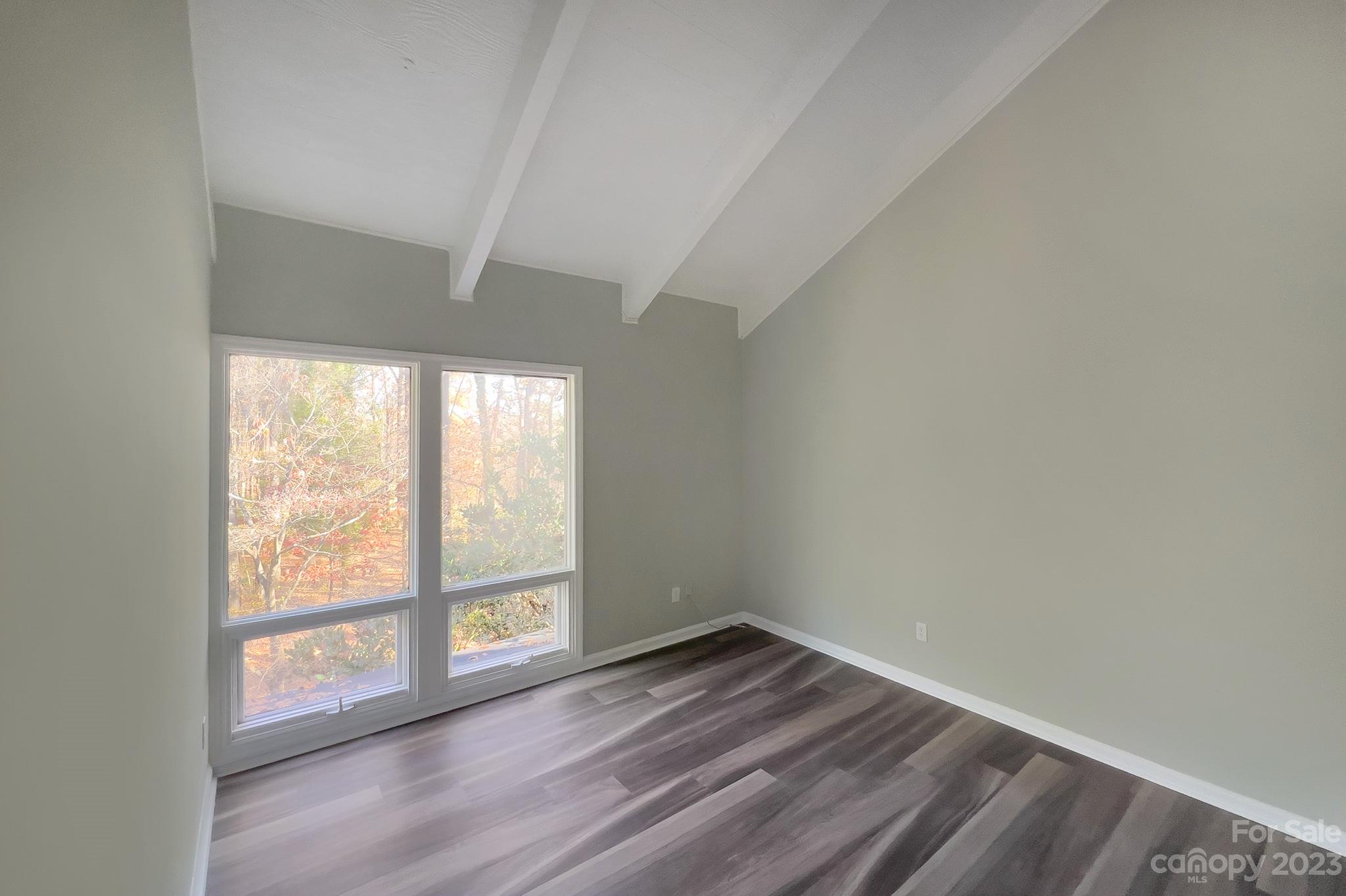 4719 Rounding Run Road Charlotte, NC 28277 - Photo 33 of 48 an empty room with wooden floor and windows