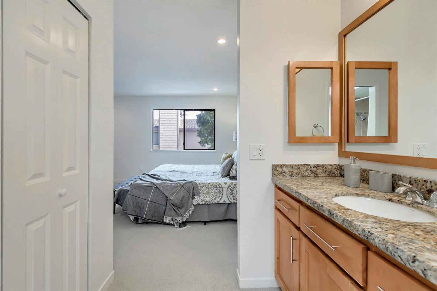 14566 South Bascom Avenue Los Gatos, CA 95032 - Photo 16 of 28 a en suite bathroom with a granite countertop sink and a mirror