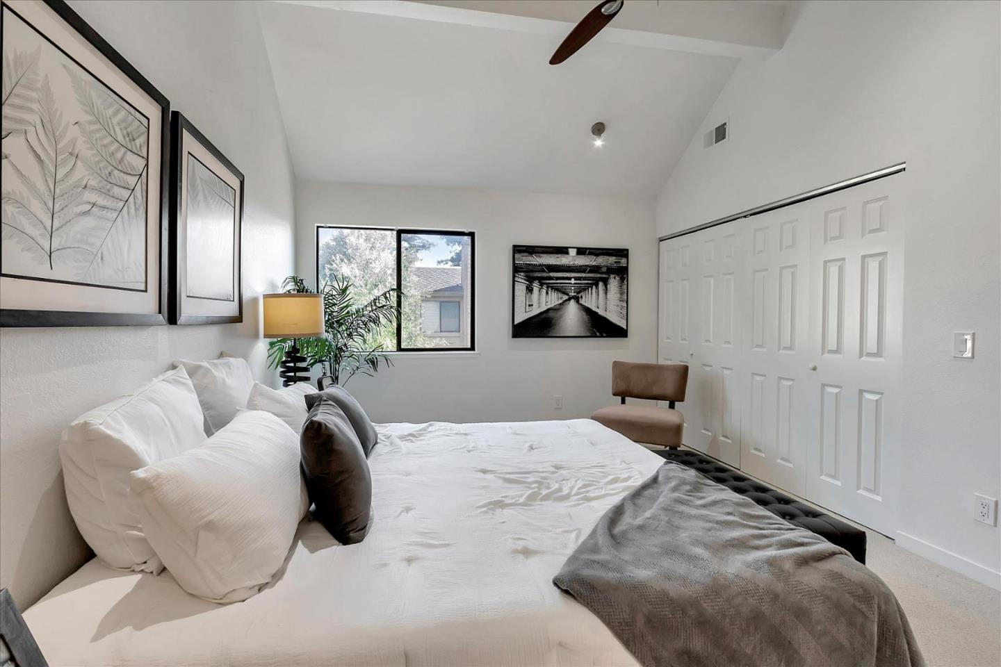 14566 South Bascom Avenue Los Gatos, CA 95032 - Photo 20 of 28 a bedroom with a bed a couch and potted plant on the dresser