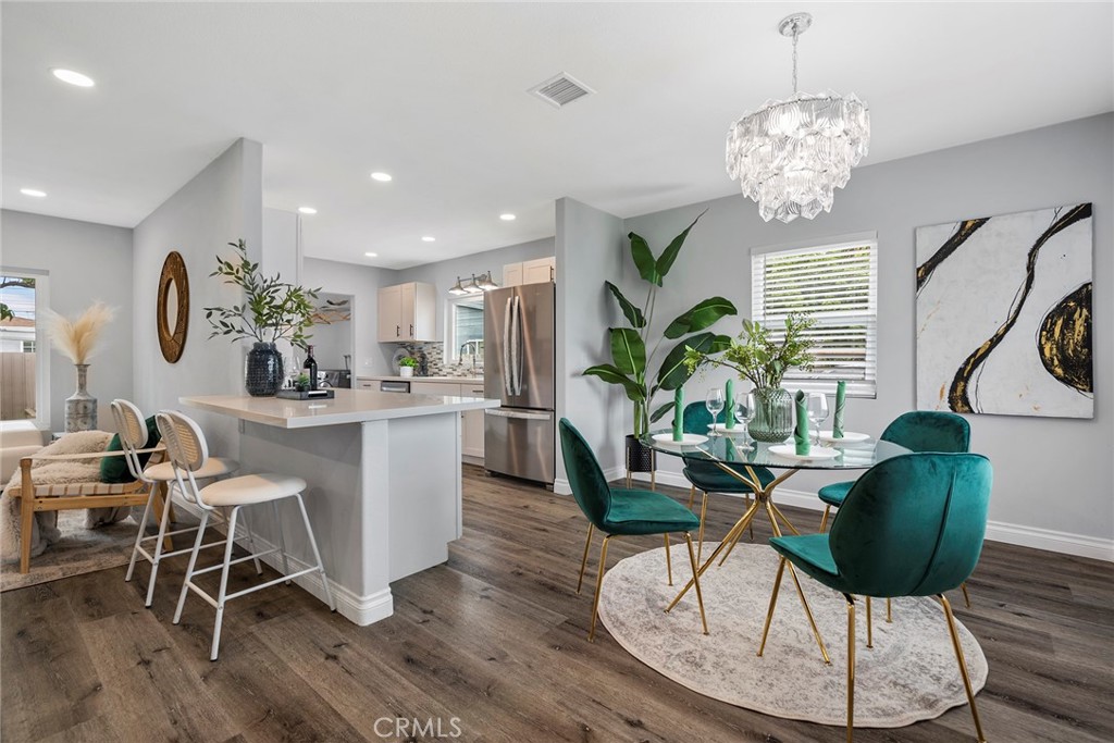 9131 Hall Road Downey, CA 90241 - Photo 11 of 32 a view of a dining room with furniture a chandelier and wooden floor