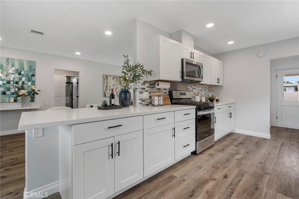 9131 Hall Road Downey, CA 90241 - Photo 14 of 32 a kitchen with stainless steel appliances white cabinets and a sink