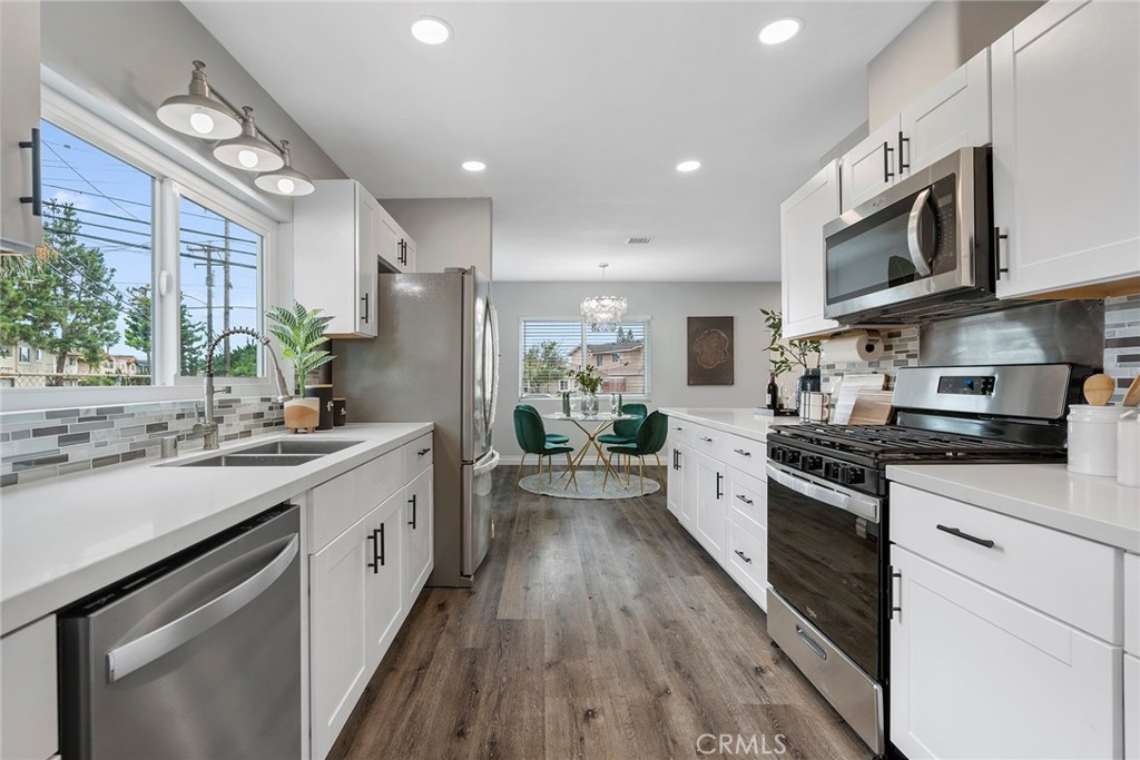 9131 Hall Road Downey, CA 90241 - Photo 18 of 32 a large kitchen with stainless steel appliances lots of counter space a sink and cabinets