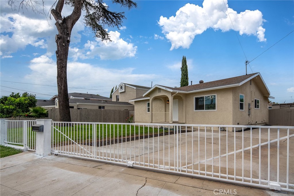 9131 Hall Road Downey, CA 90241 - Photo 2 of 32 a front view of a house with a fence
