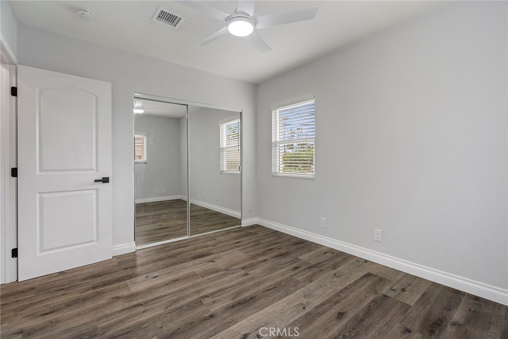 9131 Hall Road Downey, CA 90241 - Photo 26 of 32 an empty room with wooden floor closet and windows
