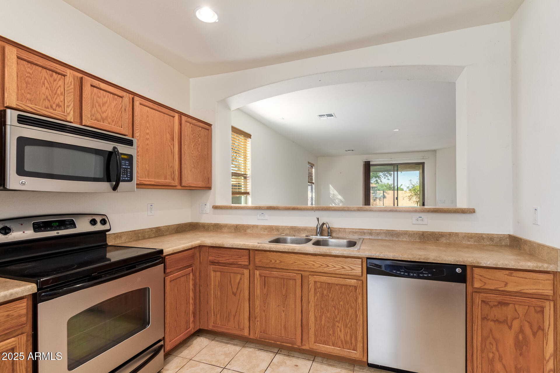2536 West Gary Way Phoenix, AZ 85041 - Photo 11 of 26 a kitchen with stainless steel appliances granite countertop a stove microwave and sink