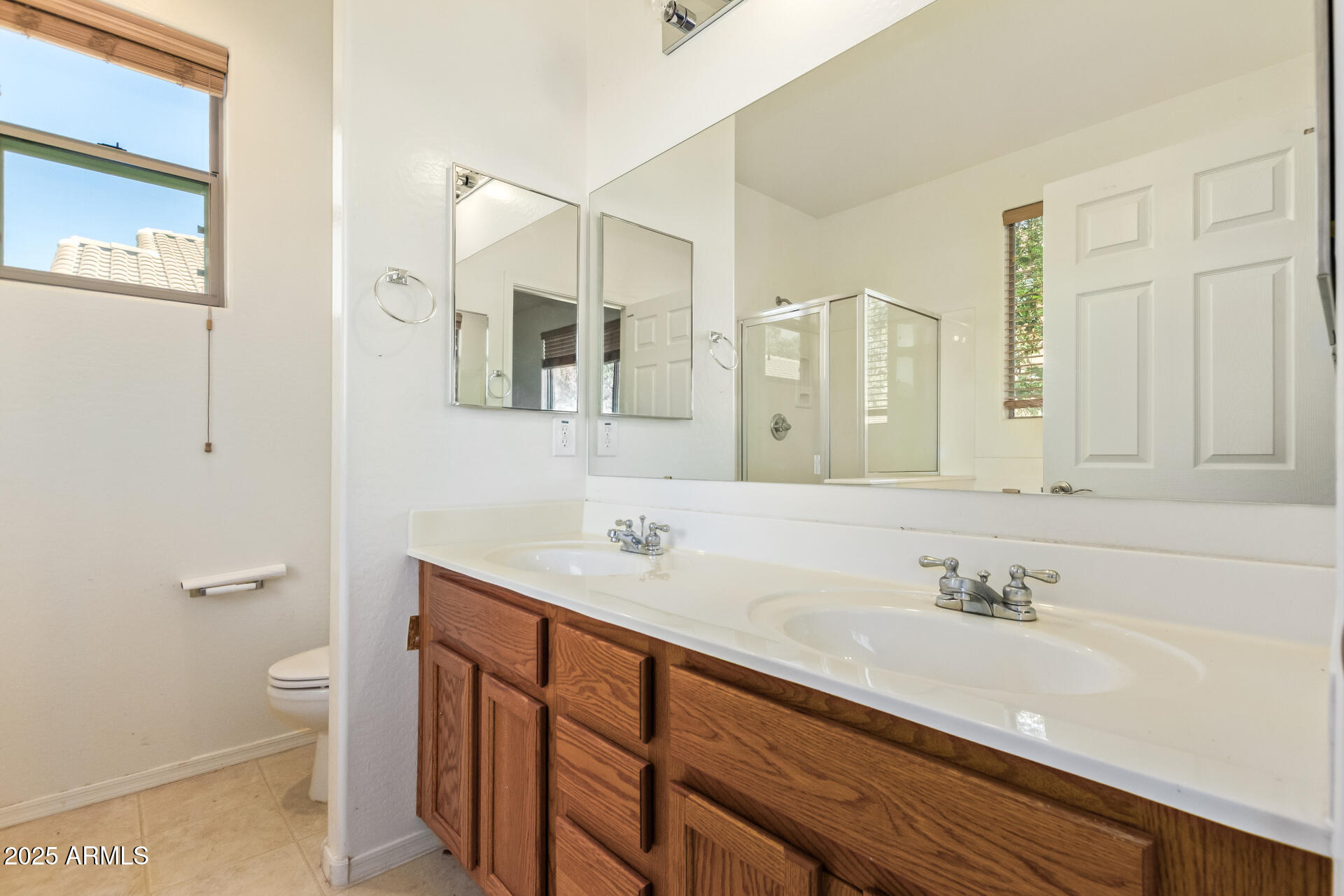 2536 West Gary Way Phoenix, AZ 85041 - Photo 16 of 26 a bathroom with a sink a toilet and a mirror