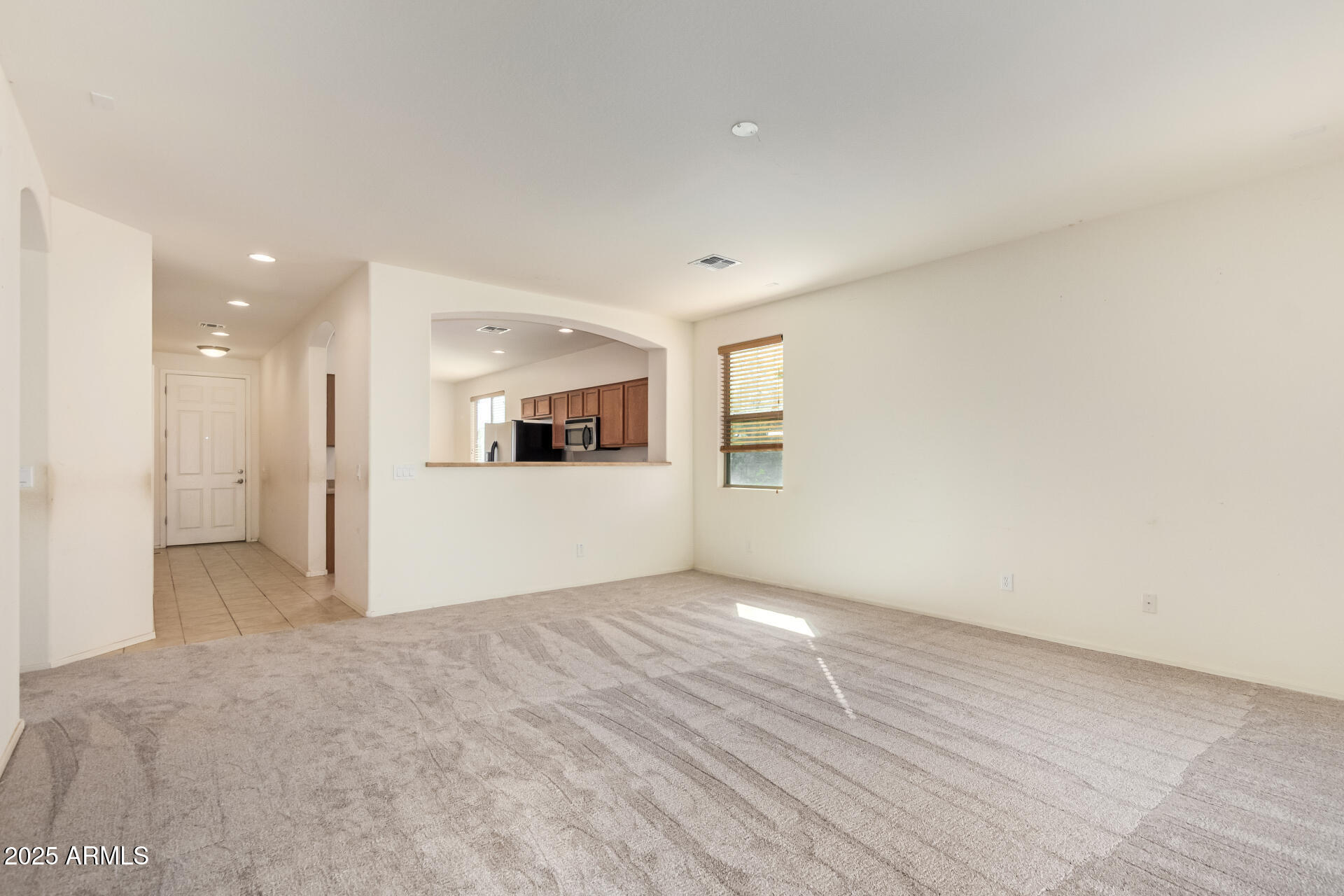 2536 West Gary Way Phoenix, AZ 85041 - Photo 6 of 26 a view of a kitchen with wooden floor and white kitchen