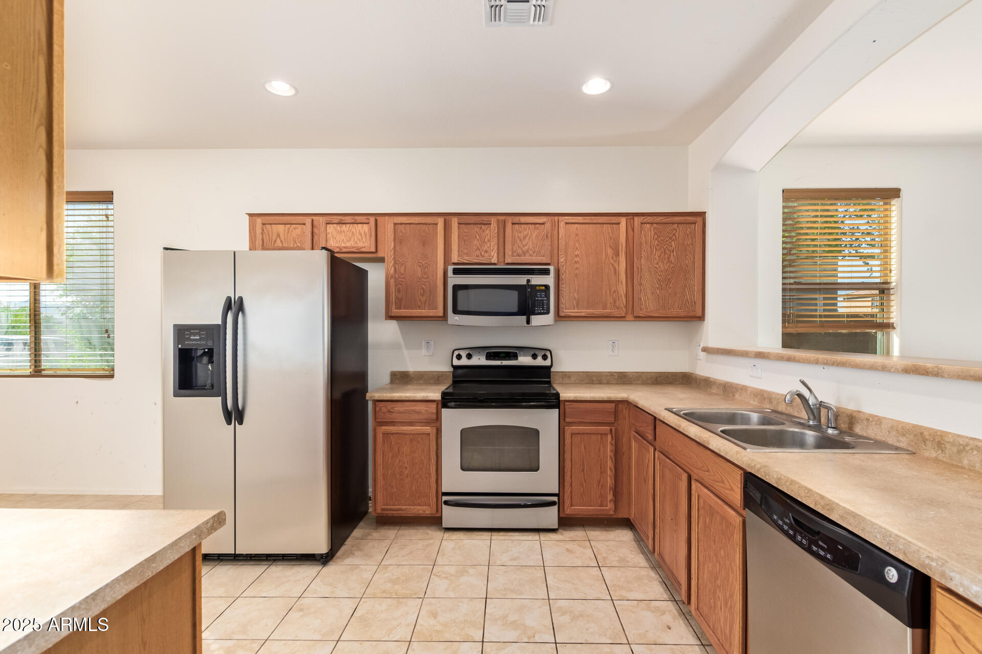 2536 West Gary Way Phoenix, AZ 85041 - Photo 9 of 26 a kitchen with a sink stove and refrigerator