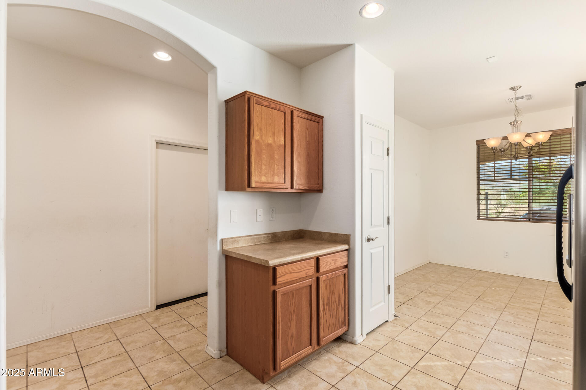 2536 West Gary Way Phoenix, AZ 85041 - Photo 10 of 26 a kitchen with granite countertop white cabinets and window