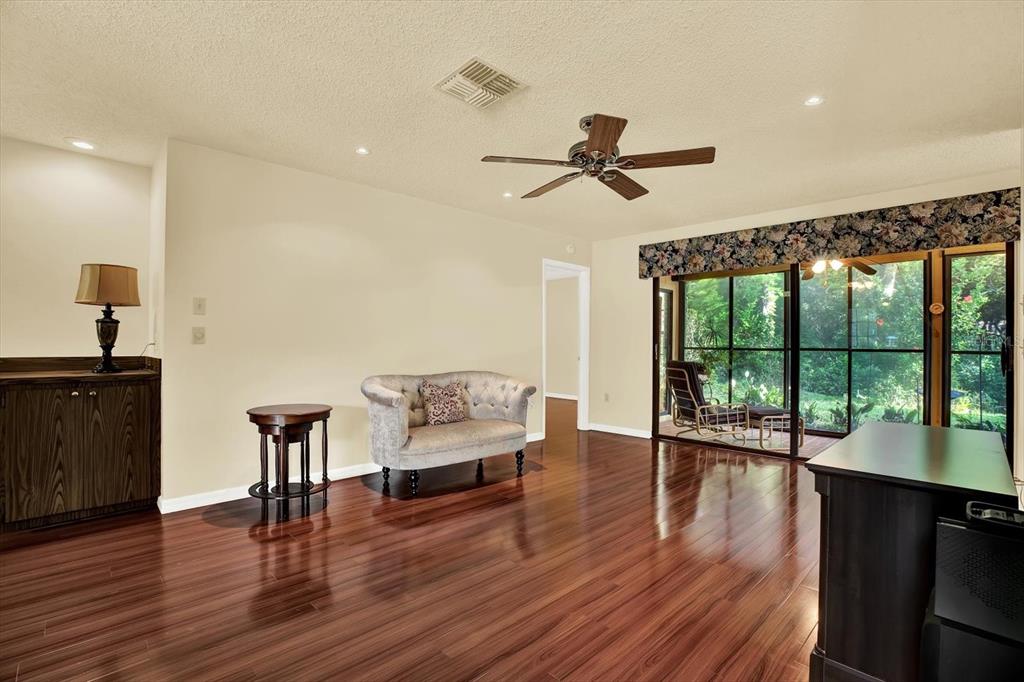 6654 Brambleleaf Drive Spring Hill, FL 34606 - Photo 2 of 27 a living room with furniture and a wooden floor