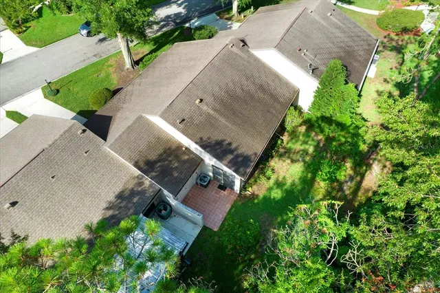 an aerial view of a house with a yard and outdoor seating