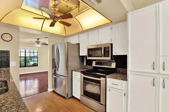 a kitchen with stainless steel appliances a stove a microwave and a refrigerator