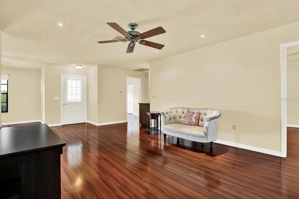6654 Brambleleaf Drive Spring Hill, FL 34606 - Photo 5 of 27 a living room with furniture and wooden floor