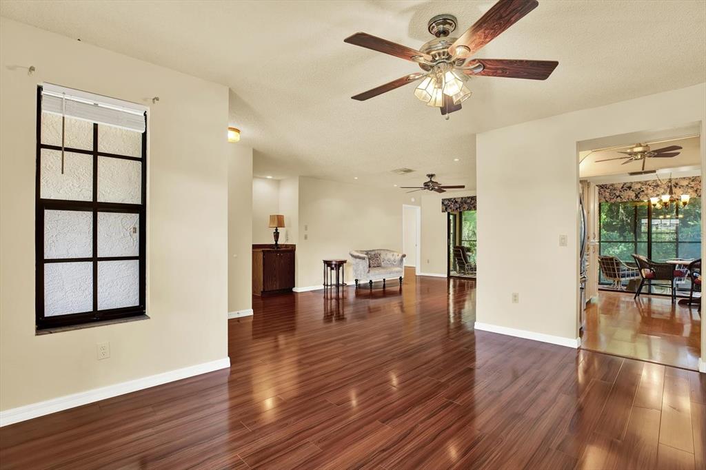 6654 Brambleleaf Drive Spring Hill, FL 34606 - Photo 7 of 27 a view of a livingroom with furniture and hardwood floor