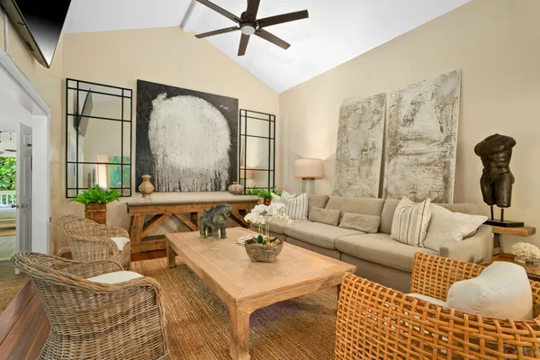 a living room with furniture and a floor to ceiling window